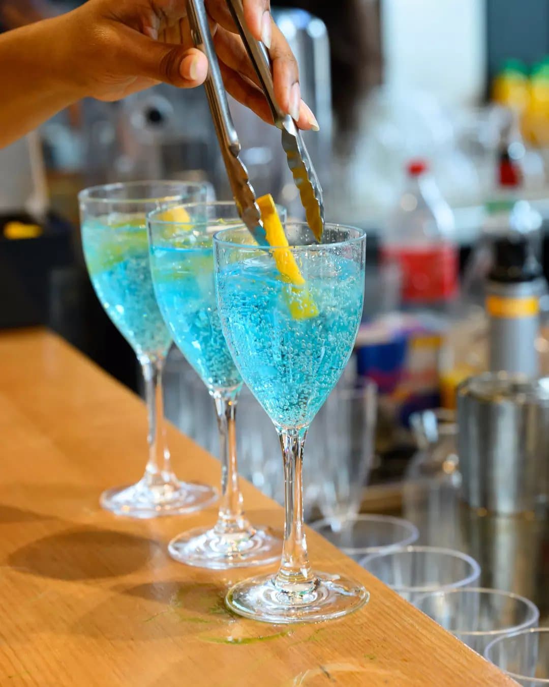 Blue lagoon cocktails being garnished