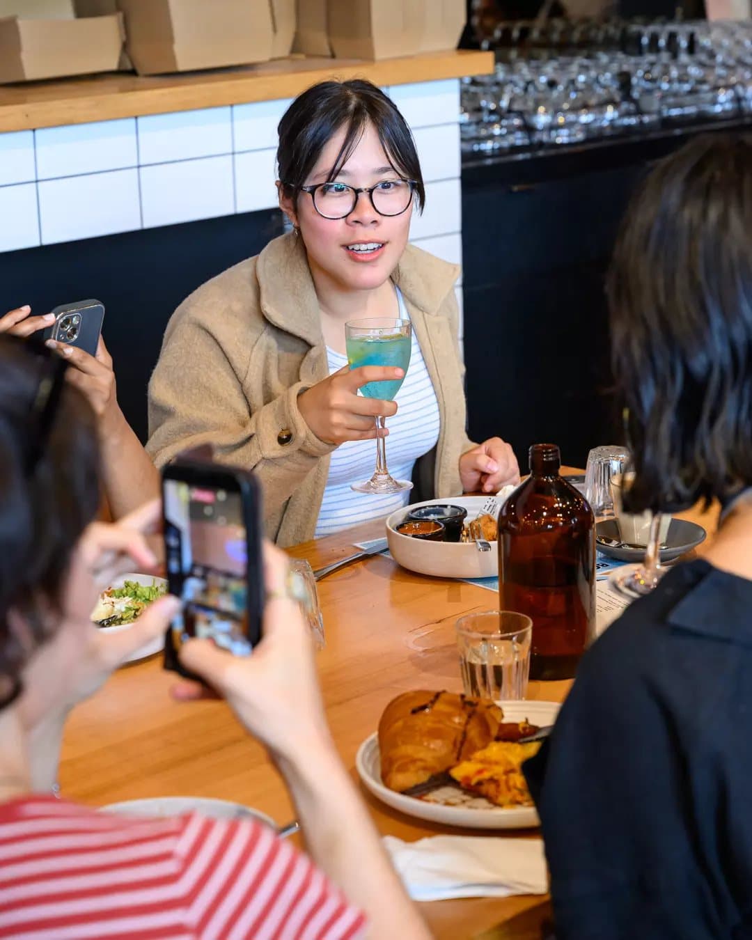 A guest photographing her brunch
